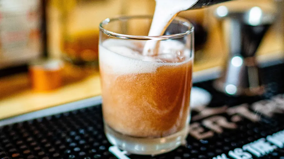 Foamy drink being poured into a glass.
