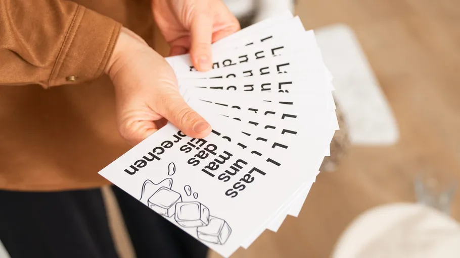 Person holding flyers with ice cube design.