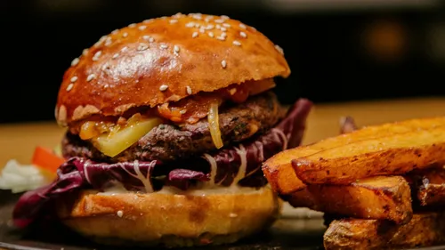 Burger with fries on a plate.