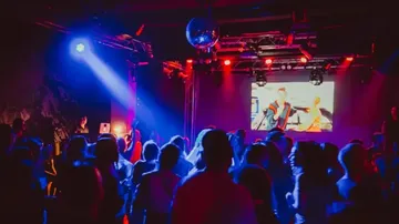 People dancing in a dimly lit club.
