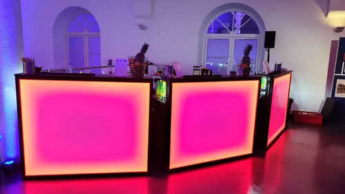 Illuminated bar in a dimly lit room.