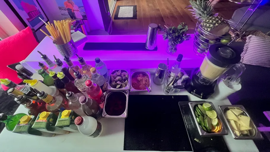 Bar counter with drink and garnish preparations.
