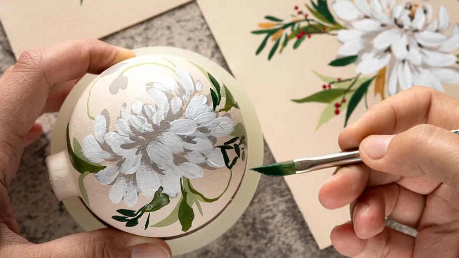 Hand painting flower on ceramic ball.