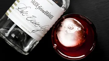 Bottle and cocktail with ice cube.