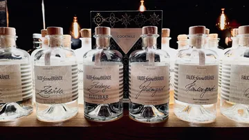 Bottles of brandy on a wooden shelf.