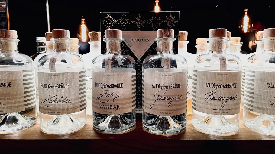 Bottles of brandy on a wooden shelf.