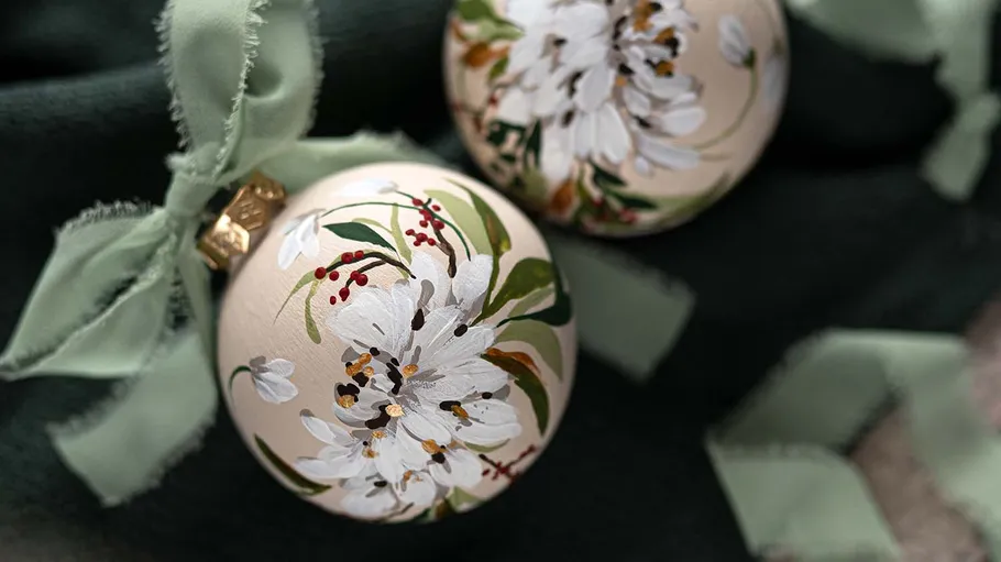 Ornaments with floral designs on dark fabric.