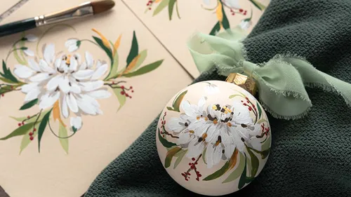 Painted ornament with white flower design.