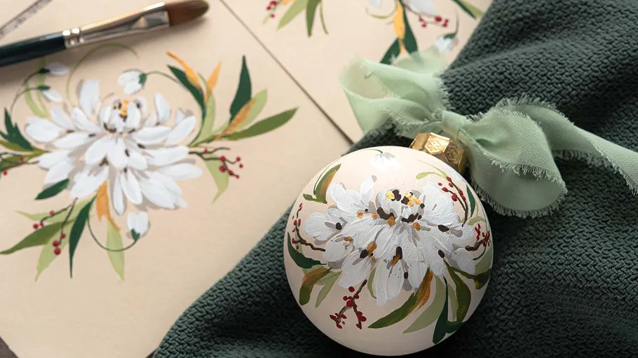 Painted ornament with white flower design.
