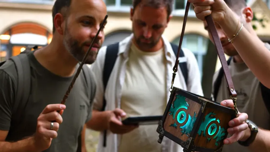 People examining magical artifact outdoors.