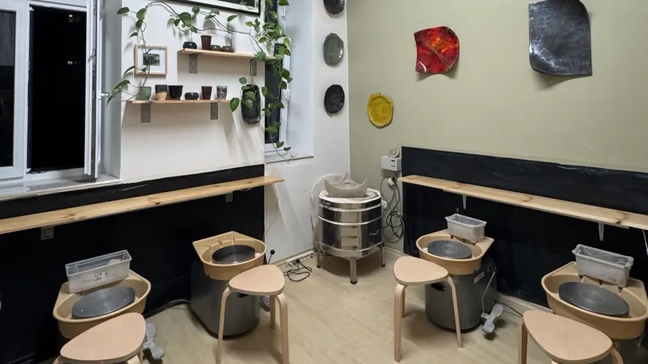 Pottery studio with wheels and kiln.