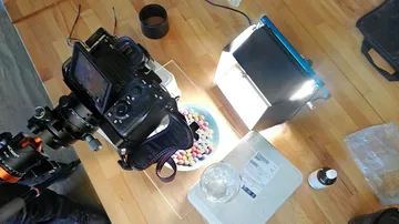 Camera setup photographing colorful candies on table.