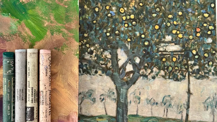 Oil pastels beside a tree painting.