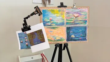 Paintings and sketches on an easel indoors.