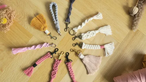 Colorful macrame keychains on wooden table.