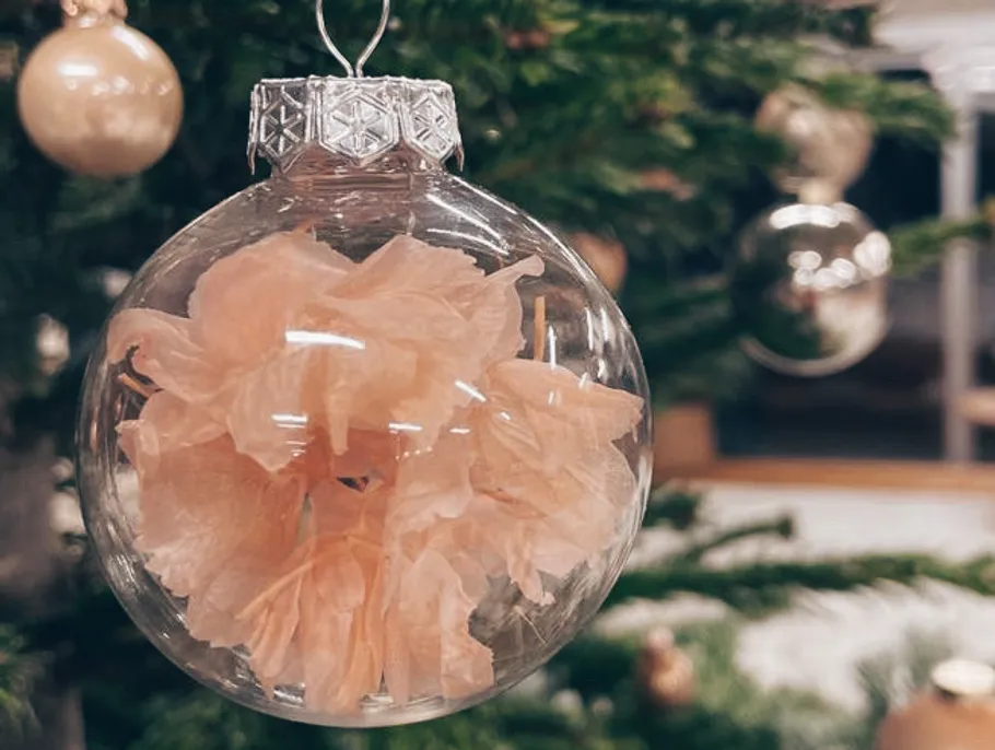 Clear ornament with pink flower inside.