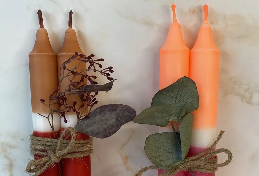 Two sets of gradient candles with foliage.