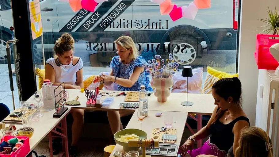 Women crafting together in a cozy store.