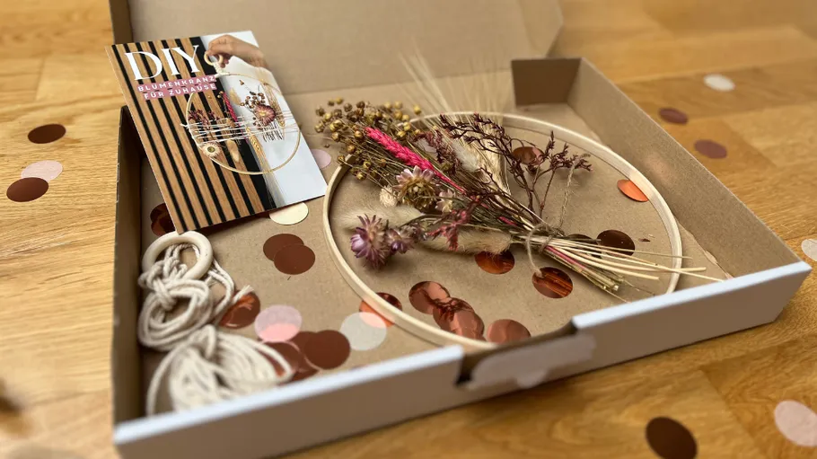 DIY floral wreath kit on wooden table.