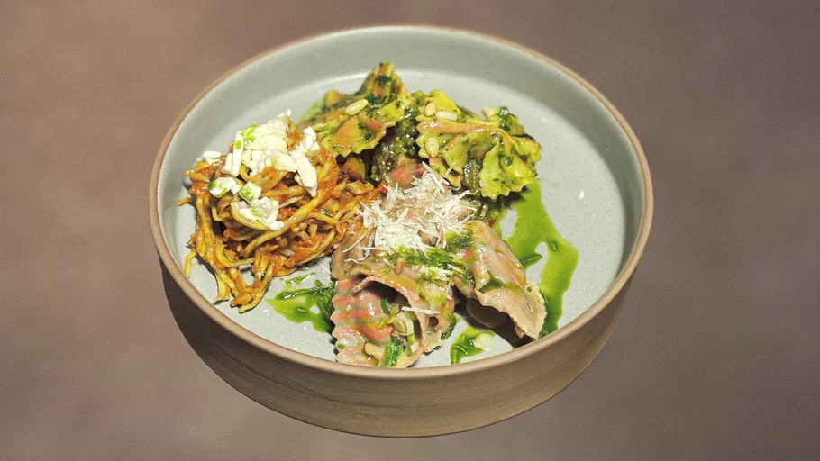 Gourmet pasta dish with various toppings.