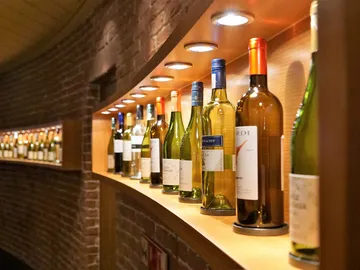Wine bottle storage on an elegant wooden shelf wall.