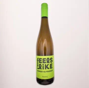 Wine bottle with green label, plain background.