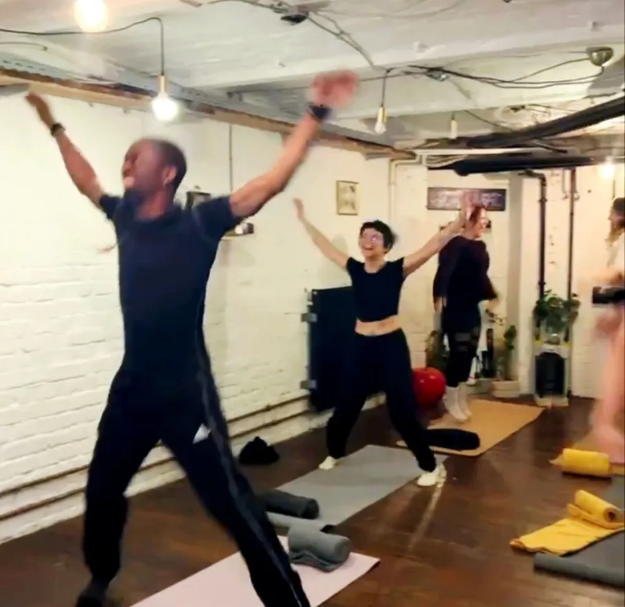 People exercising energetically in a fitness class.