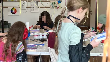 Children painting together in art class.
