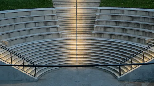 Empty amphitheater with tiered concrete seating.