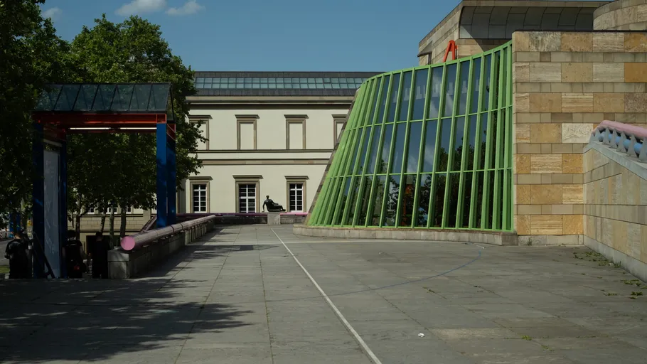Schräge grüne Fenster an Gebäudeaußenseite.