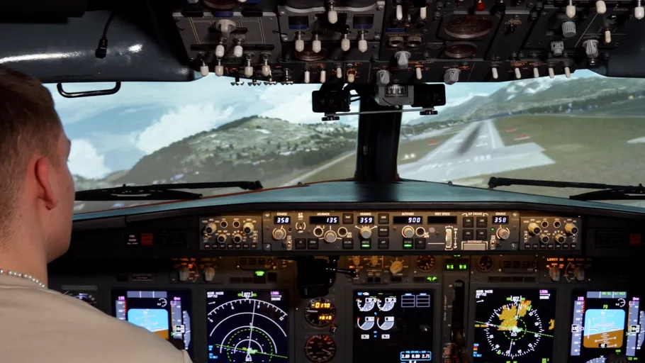 Pilot in cockpit approaching runway simulation.