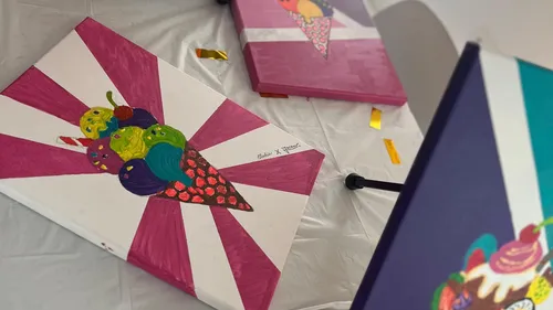 Colorful ice cream paintings on a table.