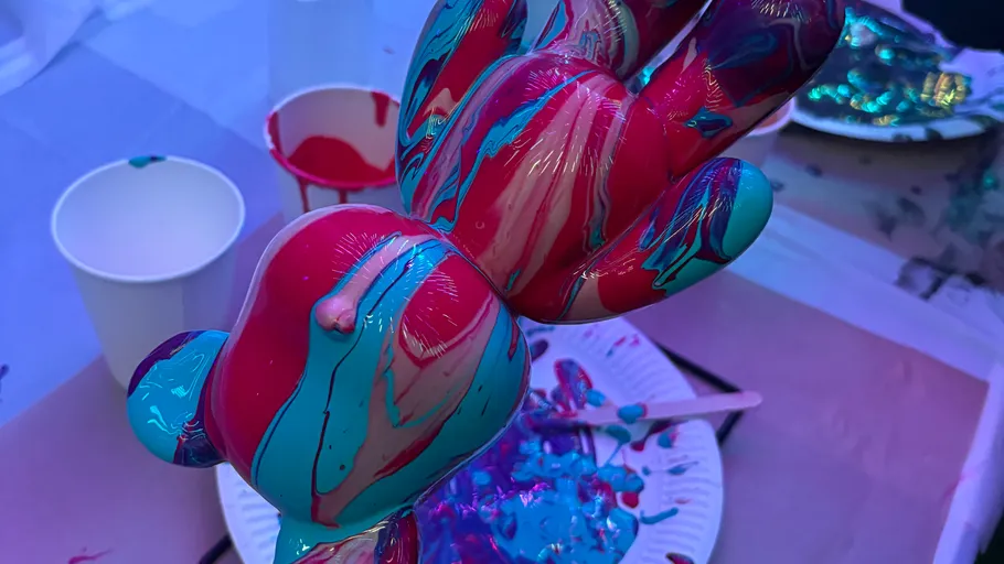 Colorful hand sculpture with dripped paint.