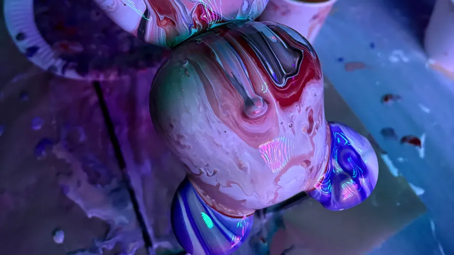 Colorful abstract sculpture with paint drips.