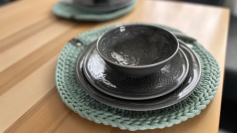 Gray bowl and plates on wooden table.
