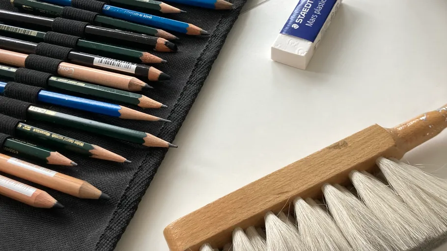 Pencils and erasers on a white surface.