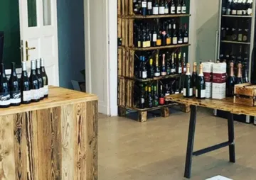 Wine racks and tables in a well-lit shop.