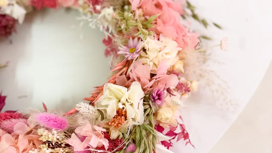 Colorful floral wreath on a white surface.