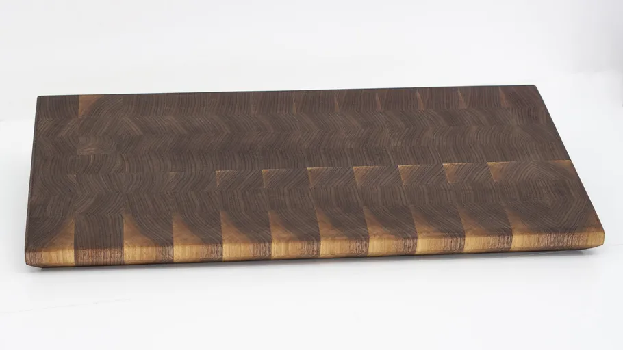 Wooden cutting board on a white surface.