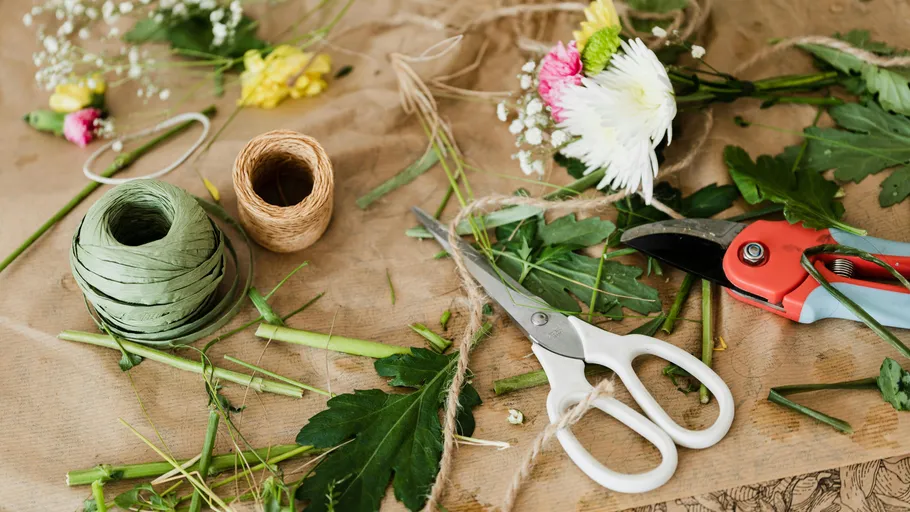 Scissors and tools for flower arrangement on paper.