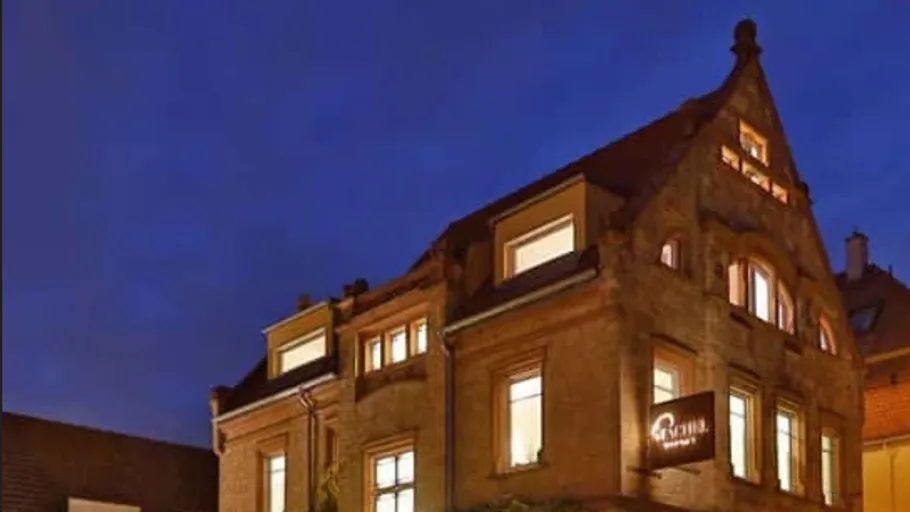 Illuminated historic building at dusk.