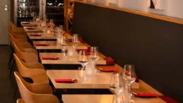 Empty restaurant tables with elegant settings.