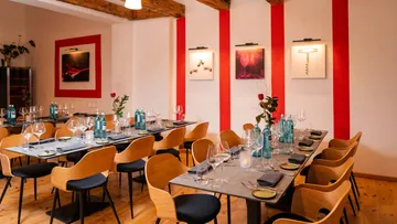 Elegant dining room with set tables and artwork.