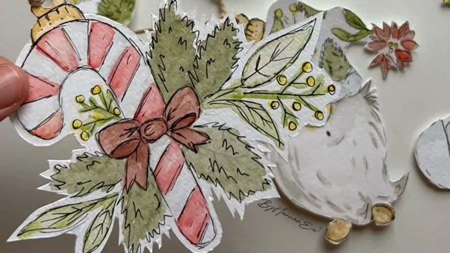 Hand hält einen dekorativen Zuckerstangen-Ausschnitt.