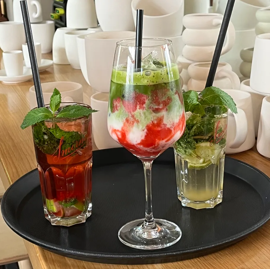 Three mixed drinks on a serving tray.