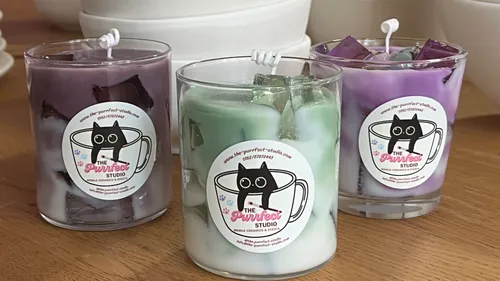 Three decorative candles with stacked bowls behind.