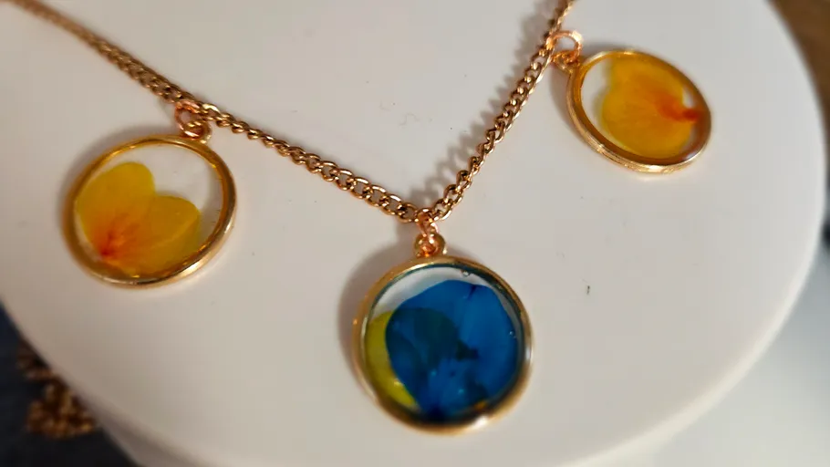 Necklace with three colorful floral pendants.