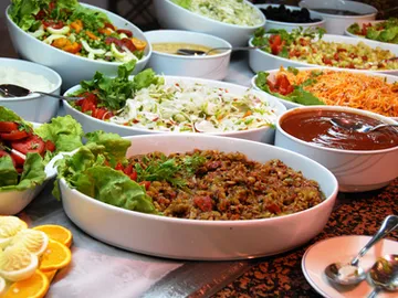 Colourful selection of salads and dishes presented on a table.