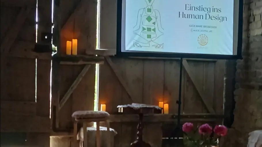 Screen presentation on human design in rustic room.