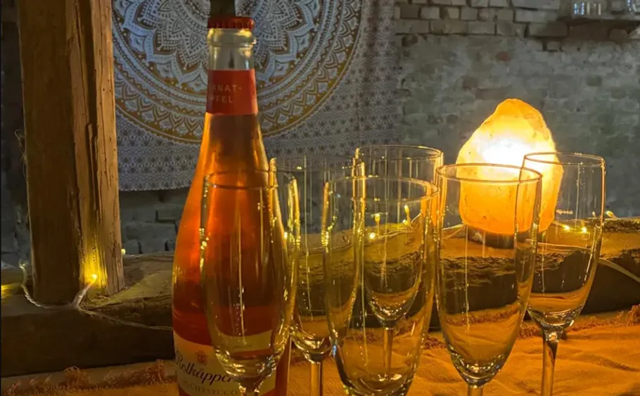 Champagne bottle and glasses on a table.